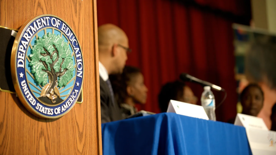 U.S. Department of Education seal on podium near panel discussion.